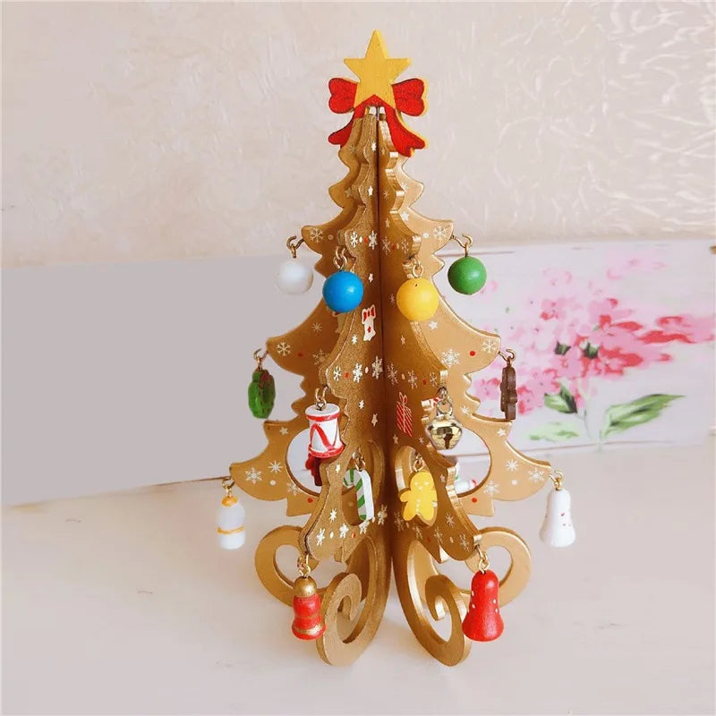 A small golden Christmas tree with colorful baubles, a red bow, and a star on top.